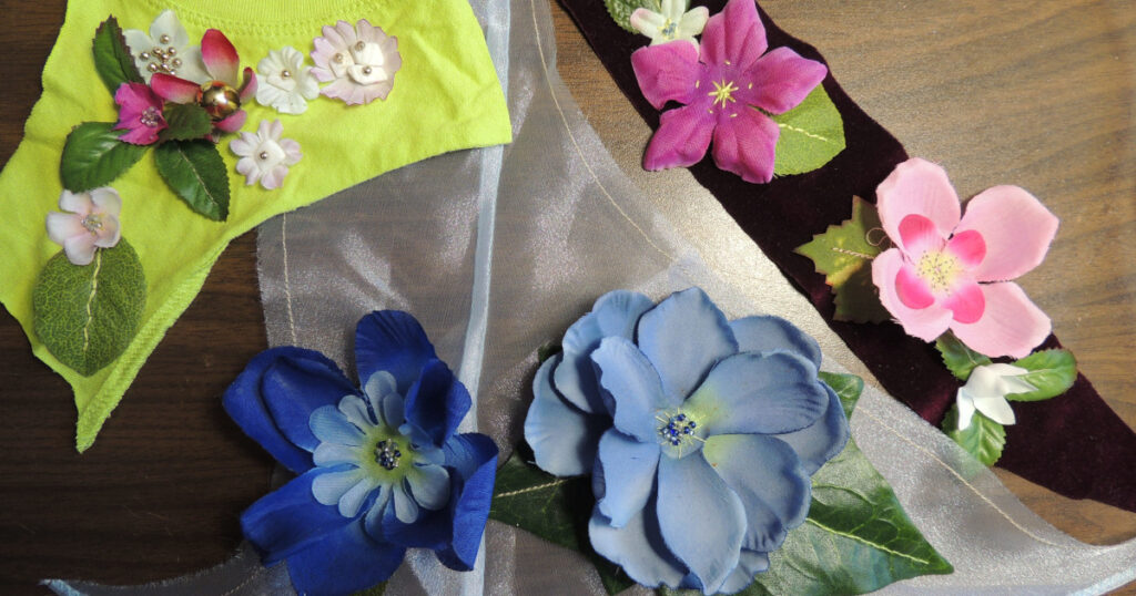 Artificial flowers attached to fabric scraps are shown before they are washed