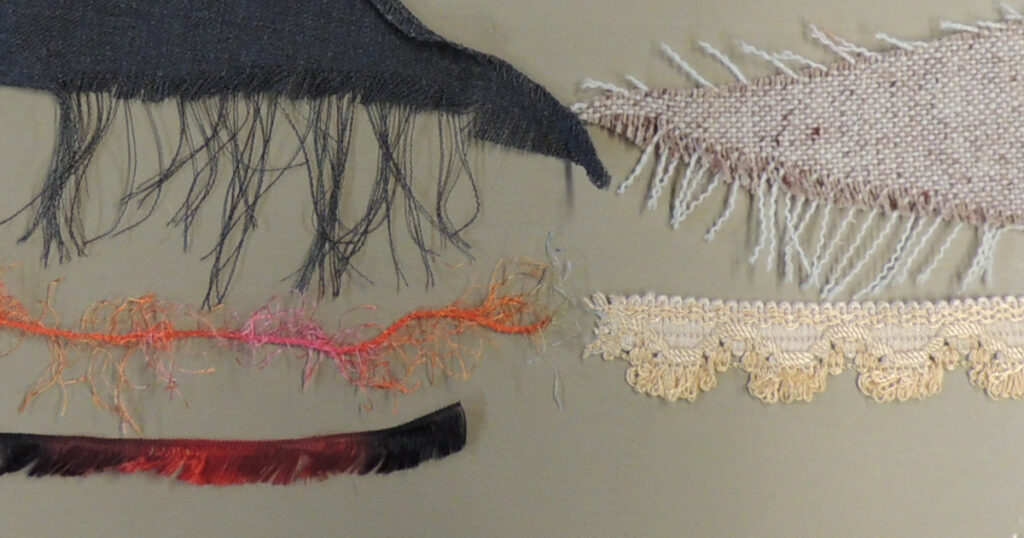 5 samples of eyelash materials are displayed:  fine cloth with a frayed edge, coarse cloth with a frayed edge, fuzzy yarn, commercially made fringe trim, and eyelash yarn
