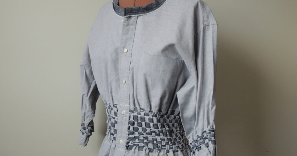 Gray and black tunic made from a man's gray business shirt with black bands woven in for shaping and neckline trim.