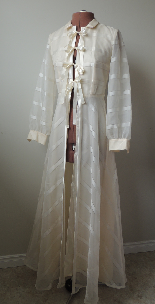 Long sleeved vintage wedding gown converted to a dressing gown or lightweight coat. Satin ribbon ties close front with bows.