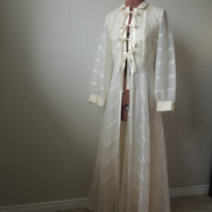 Long sleeved vintage wedding dress converted to dressing gown or lightweight coat. Front closes with satin ribbon ties.